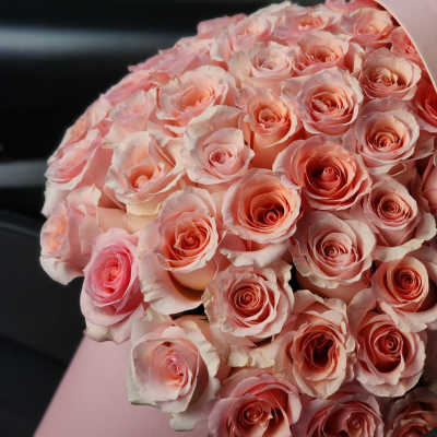 Bouquet of pale pink roses wrapped in pink paper
