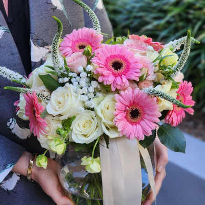 Bouquet of pink gerbera daisies and white roses in a glass vase