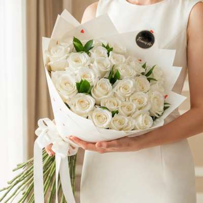 Bouquet of white roses wrapped in white paper
