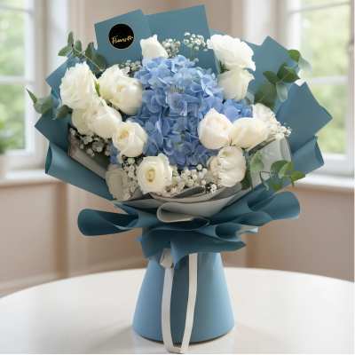 Blue and white bouquet of roses and hydrangeas wrapped in teal paper