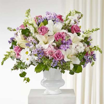 Pink and white mixed flower arrangement in a white vase