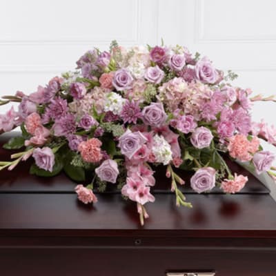 Large pink and lavender floral casket spray with roses and carnations
