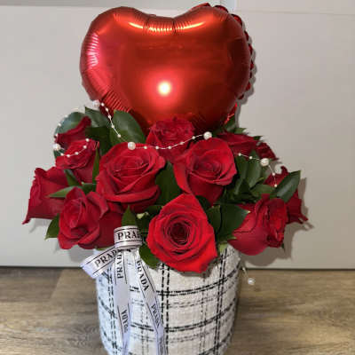 Red roses in a patterned box with a red heart balloon