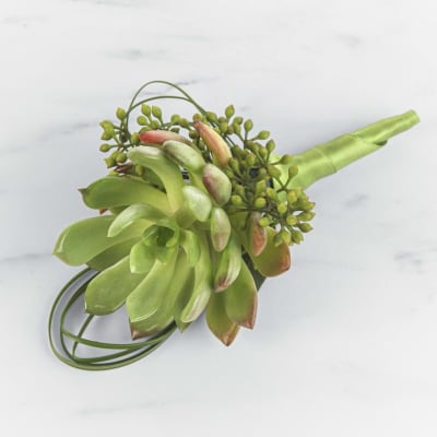 Succulent boutonniere with small green berries and a green ribbon-wrapped stem