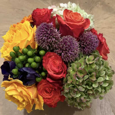 Colorful bouquet of roses, purple allium, and hydrangea blooms