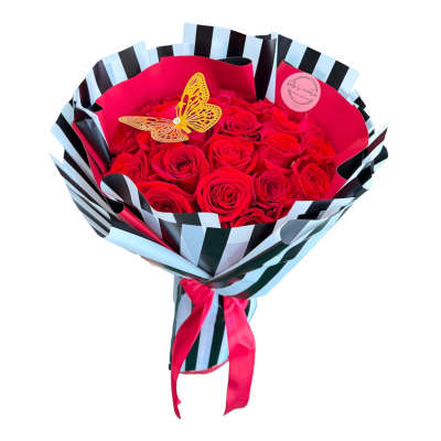 Bouquet of red roses wrapped in striped paper with a butterfly topper