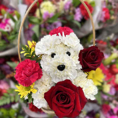 Flower basket shaped like a white dog with red roses and pink carnations