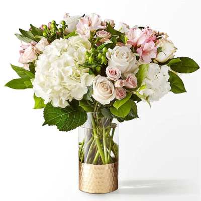 Bouquet of white and pale pink flowers in a glass vase