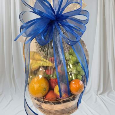 Fruit basket wrapped in clear cellophane with a large blue bow