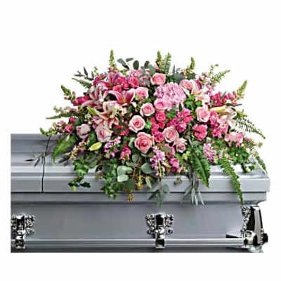 Pink floral casket spray on a silver casket