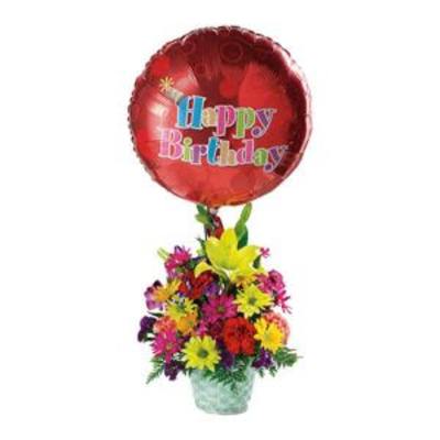 Birthday balloon above a colorful mixed flower arrangement in a vase