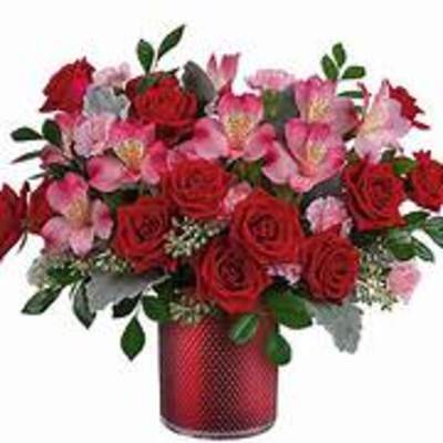 Red roses and pink alstroemeria in a red vase