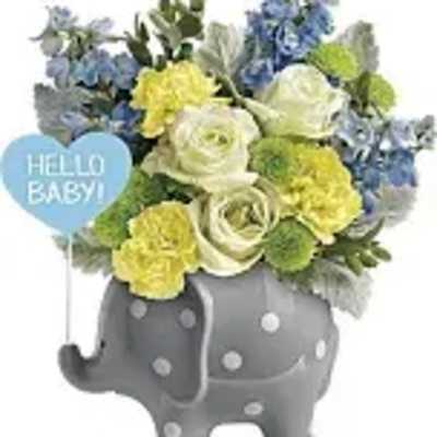 Flower arrangement in a gray elephant planter with a "Hello Baby!" sign