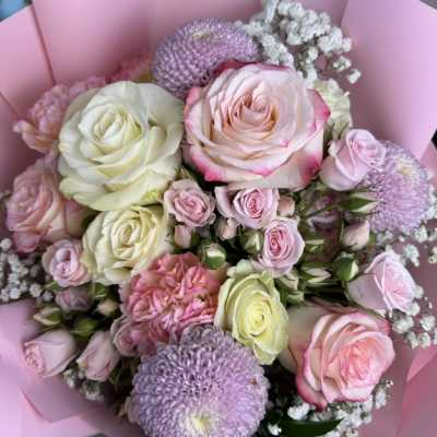Pink and white rose bouquet with lavender blooms wrapped in pink paper