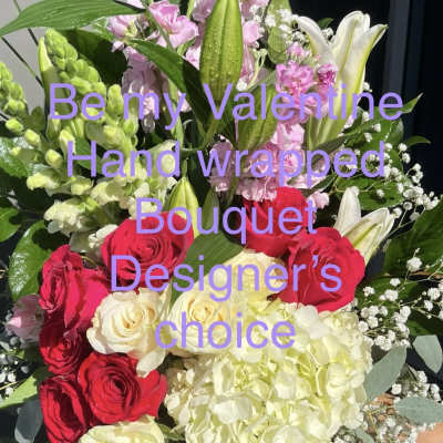 Hand-wrapped bouquet of red and cream roses with pink lilies