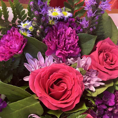Bouquet of hot pink roses and purple chrysanthemums with small daisy flowers