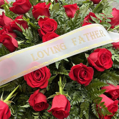 Red roses with a "Loving Father" ribbon