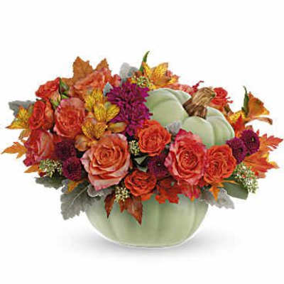 Autumn floral arrangement in a pale green pumpkin vase
