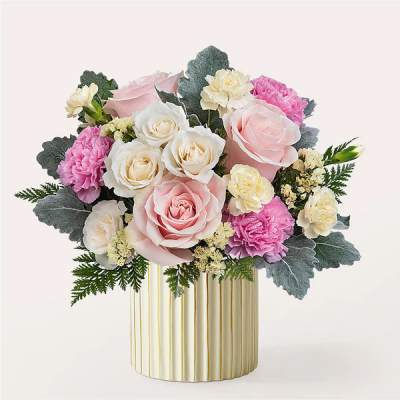 Pink and white rose bouquet in a gold-striped vase