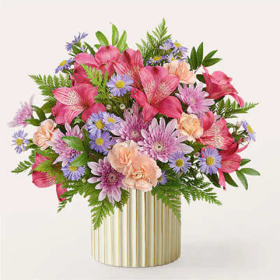 Pink and lavender mixed bouquet in a striped gold vase