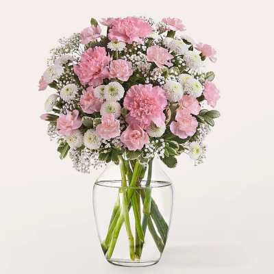 Pink and white bouquet in a clear glass vase