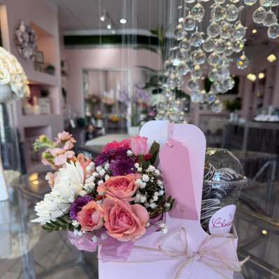 Pink and white bouquet in a pastel gift box with a ribbon