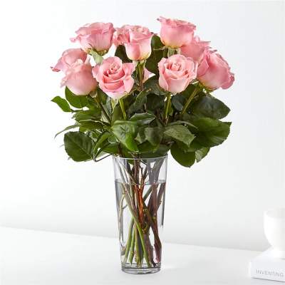 Pink roses arranged in a clear glass vase