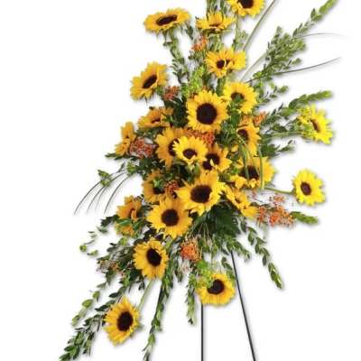 Tall standing spray of yellow sunflowers with cascading greenery on a metal easel.