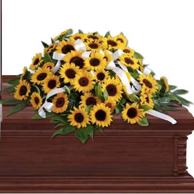 Sunflower casket spray with white ribbons on a wooden casket