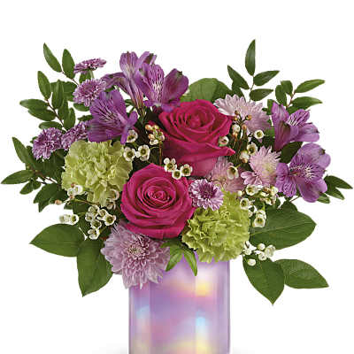 Pink roses and purple flowers arranged in an iridescent glass vase