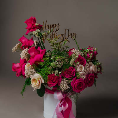 Pink and cream roses in a white box with a "Happy Mother's Day" topper