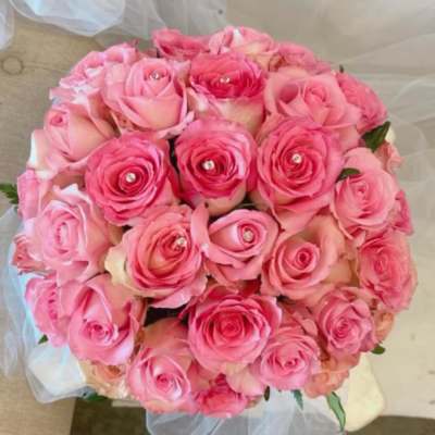Round bouquet of pink roses with clear gem centers