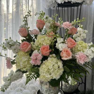 Pink roses and white hydrangeas in a silver vase