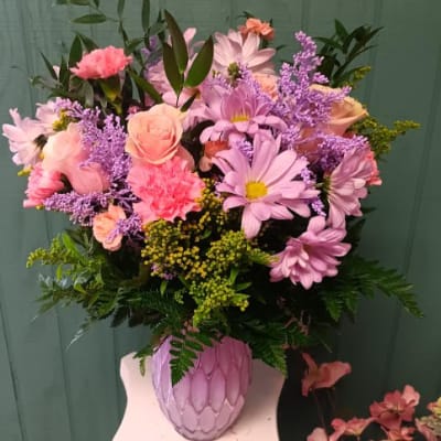 Pink and lavender mixed bouquet in a textured pink vase