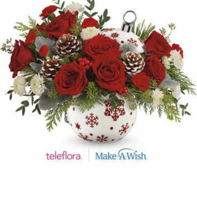 Red roses and white flowers in a snowflake-patterned vase
