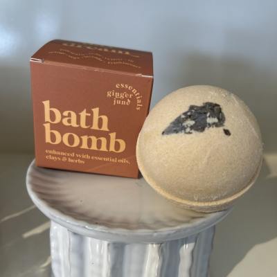 Bath bomb and boxed bath product on a small ceramic pedestal