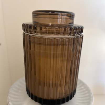 Amber ribbed glass jar candle with a lid