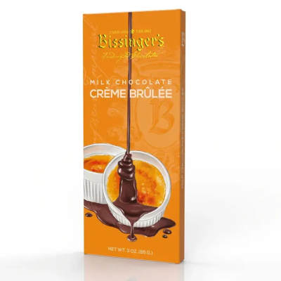 Orange box of milk chocolate crème brûlée bar with ramekins and chocolate drizzle illustration