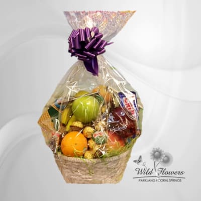 Gift basket with fruit and chocolates wrapped in clear cellophane