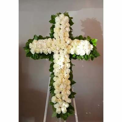 White rose cross-shaped floral tribute on an easel