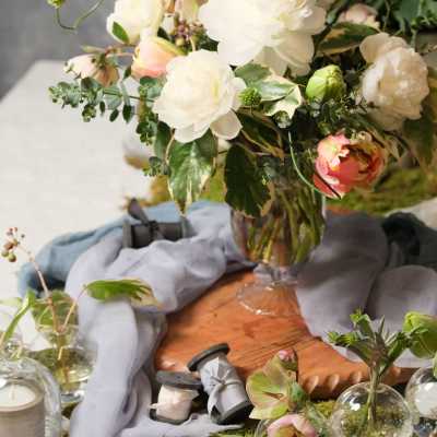 White and blush flowers arranged in a clear glass vase