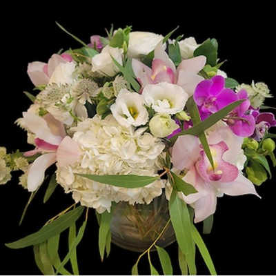 Pink and white floral arrangement in a glass vase