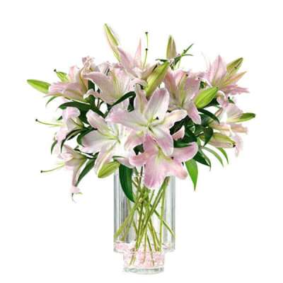 Pink lilies arranged in a clear glass vase