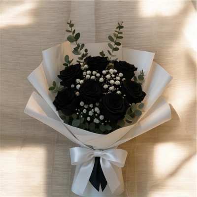 Bouquet of black roses with white baby's breath and eucalyptus in white wrap