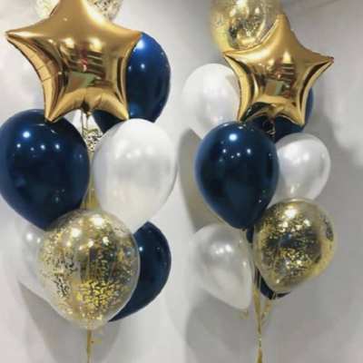 Two balloon bouquets with gold star balloons, navy and white balloons, and confetti balloons
