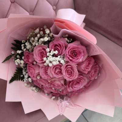 Pink rose bouquet with white baby's breath in pink wrapping