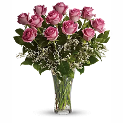 Pink roses arranged in a clear glass vase with white filler flowers
