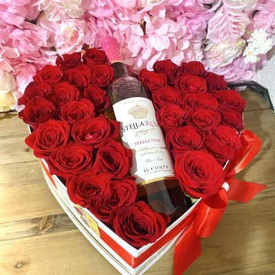 Heart-shaped rose arrangement with a wine bottle in a gift box
