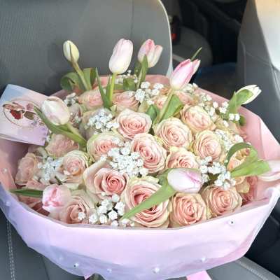 Pink rose and tulip bouquet wrapped in pastel paper