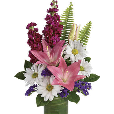 Pink lilies and white daisies in a green glass vase